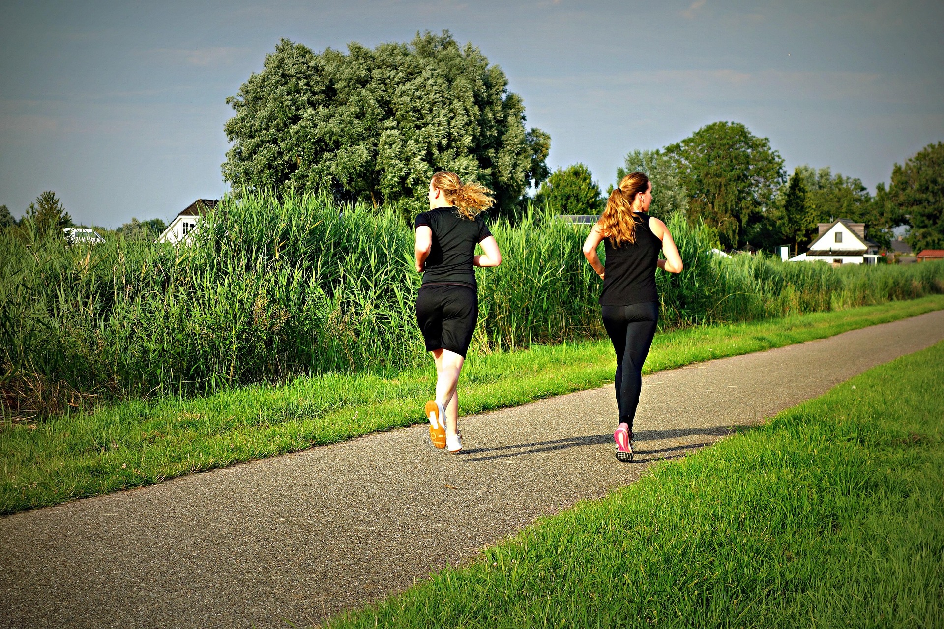 A coach timing runners with a stopwatch